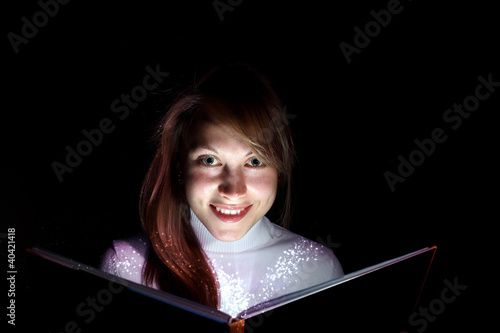 Young woman reading a magic book © Sergey Nivens