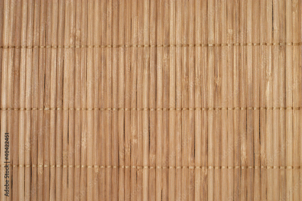 Fototapeta premium Brązowa mata ze słomy pionowe tło zbliżenie