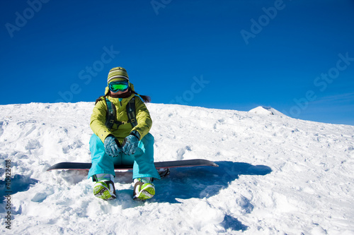 Snowboarder girl sitting
