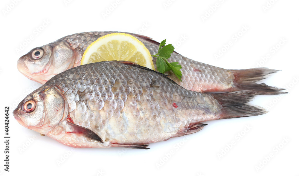 Fresh fishes with lemon and parsley isolated on white