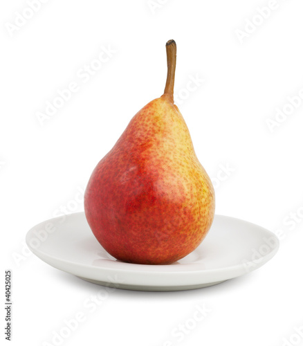 Ripe pear and saucer
