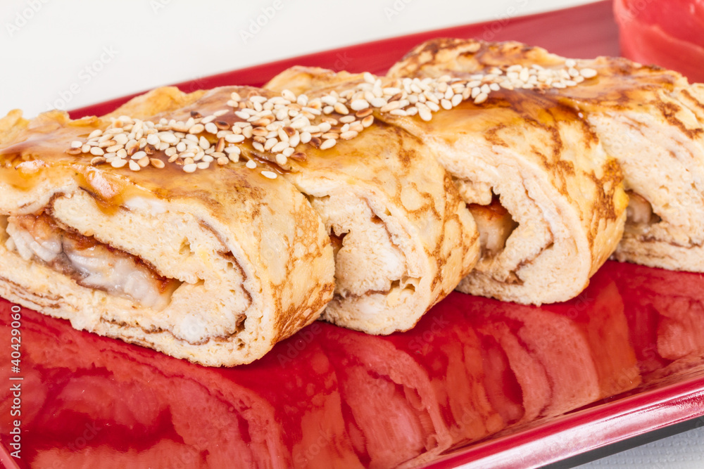 Omelet Maki Sushi - Roll made of Smoked Eel inside. Topped with Omelet Maki Sushi - Roll made of Smoked Eel inside. Topped with