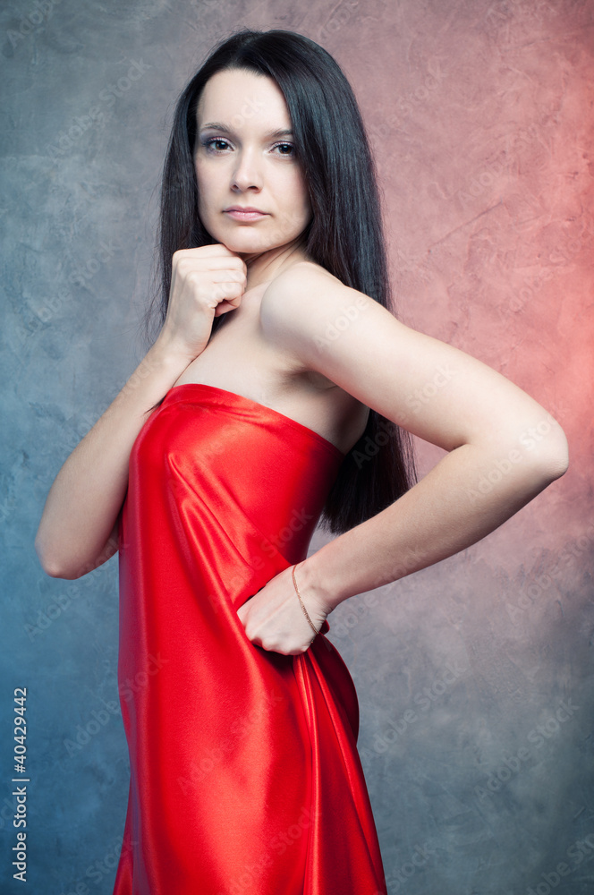Obraz premium Studio portrait of sensual young woman with long dark hair