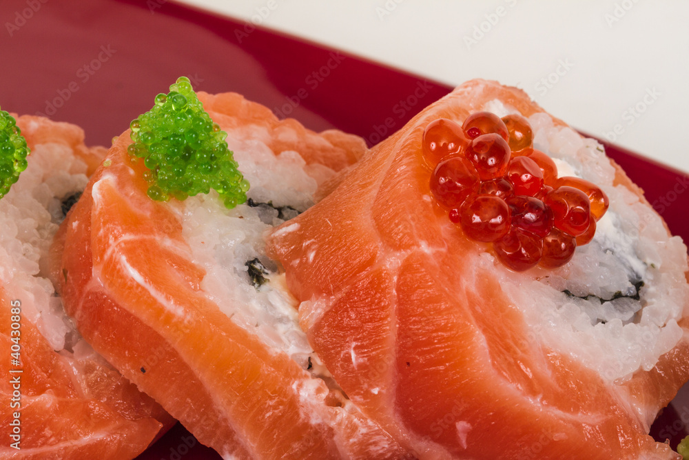 Japanese sushi traditional japanese food.Roll made of salmon, re Japanese sushi traditional japanese food.Roll made of salmon, re