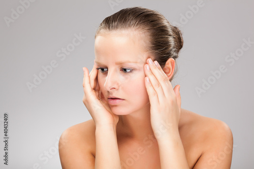 Woman massaging pain head