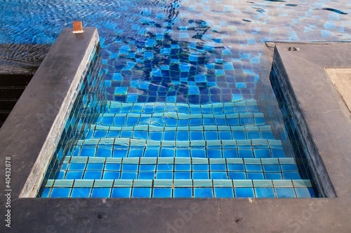 A swimming pool with stairs.