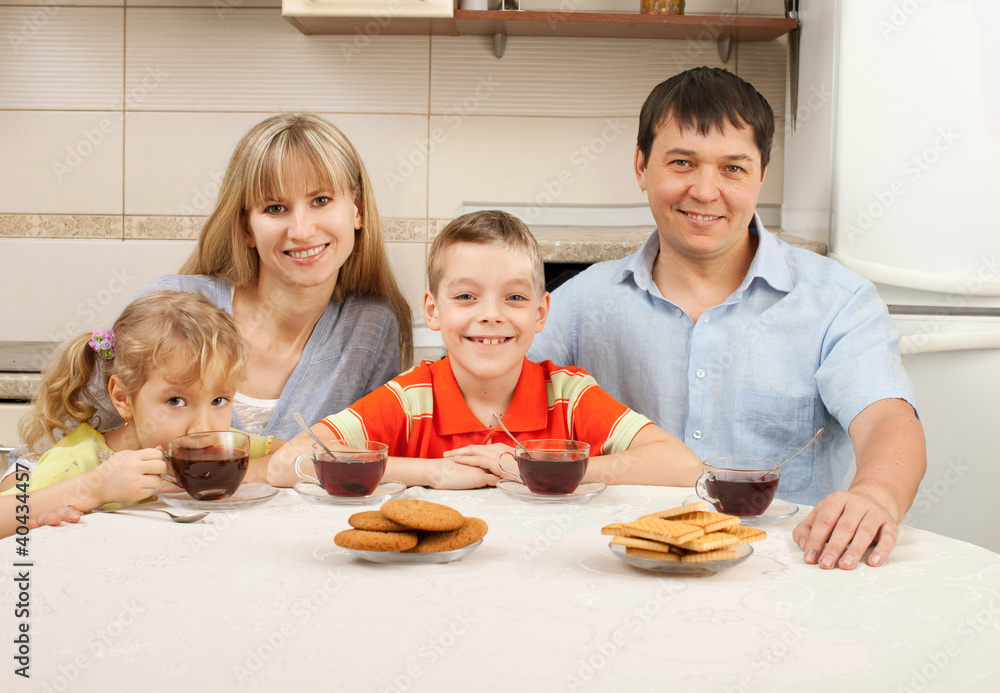 Happy family drinks tea