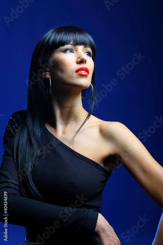 Beautiful woman on a dark blue