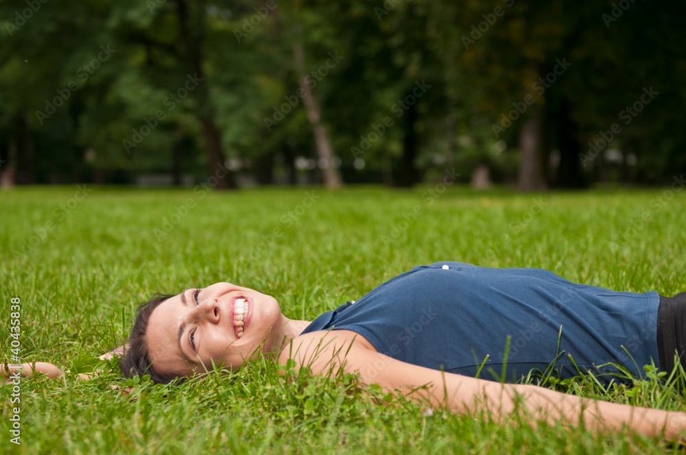 Enjoying life - woman lying in grass Enjoying life - woman lying in grass