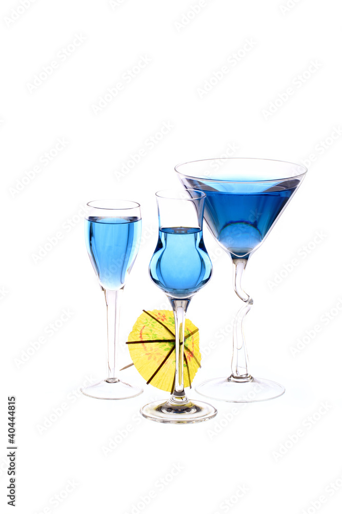 Three wineglasses are filled with beverage and cocktail umbrella