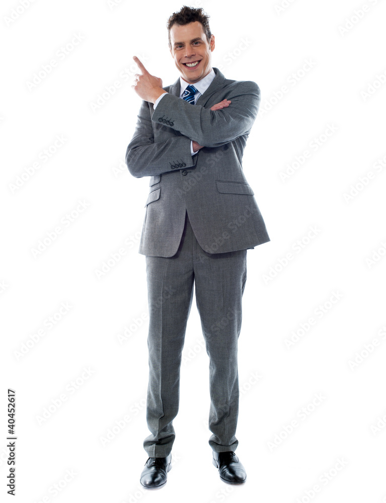 Businessman in suit pointing at copyspace Businessman in suit pointing at copyspace