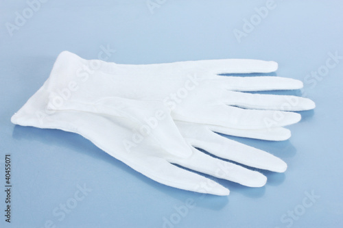cloth gloves on blue background. © Africa Studio