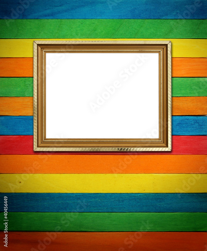 Gold frame on colorful wood Background