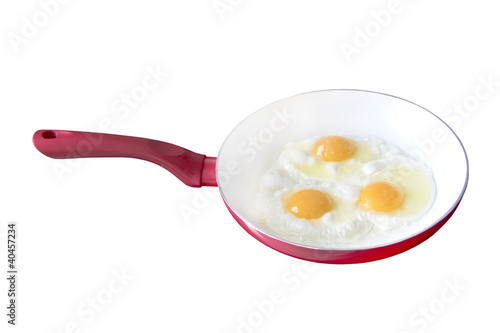 Fried eggs in a frying pan, white background