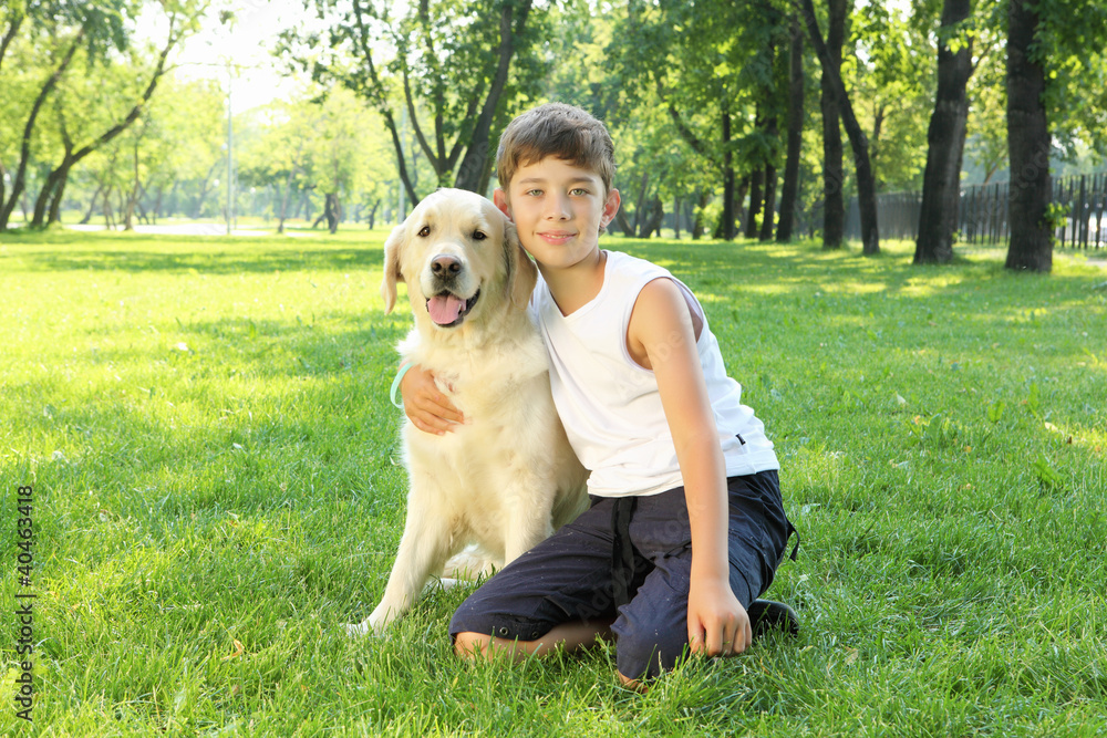 Tennager boy in the park with a dog Tennager boy in the park with a dog