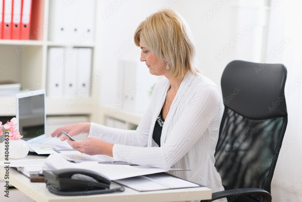 Senior business woman working with documents Senior business woman working with documents
