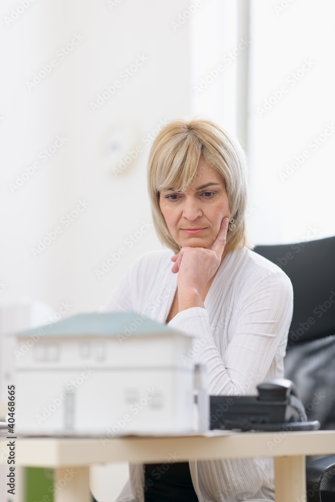 Thoughtful middle age architect woman at work Thoughtful middle age architect woman at work