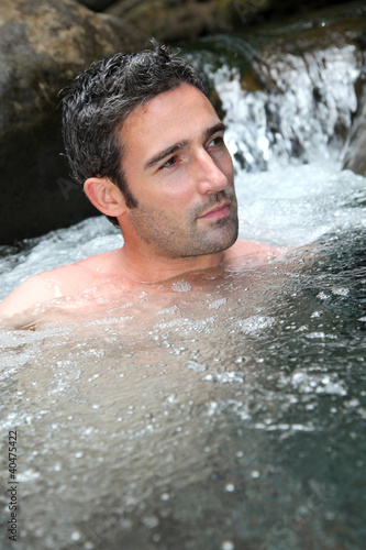 Closeup of man bathing in natural river water