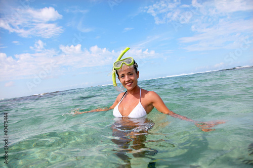 Smiling woman in water with snorkeling outfit