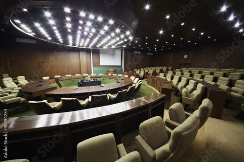 Auditorium for the meeting with round table, rostrum and chairs