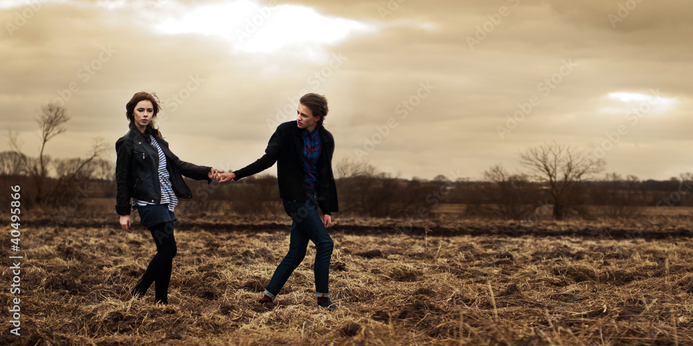 beautiful couple posing in a spring field