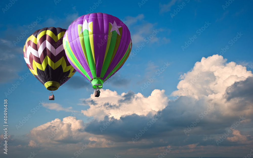 Fototapeta premium Hot air balloons in blue sky cloud formations