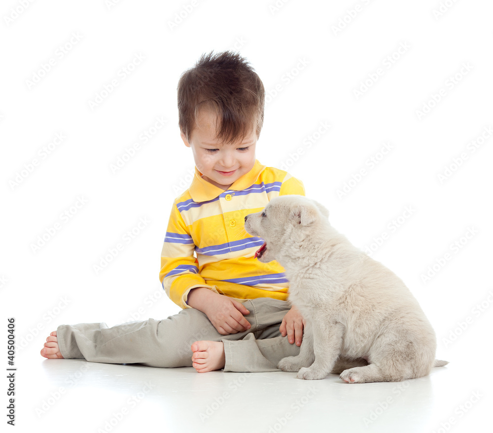 smiling child playing with a puppy smiling child playing with a puppy