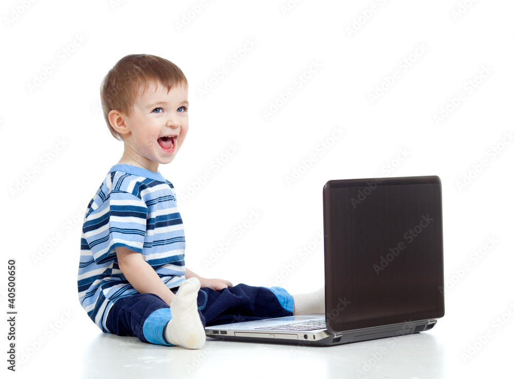 Funny child using a laptop over white background