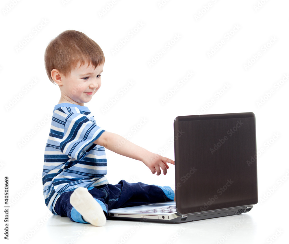 Funny child touching to laptop over white background Funny child touching to laptop over white background