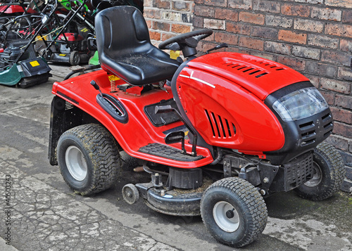 A bright red ride on lawnmower 