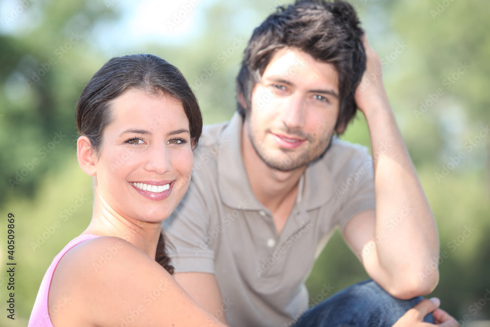Happy couple sat in the park Happy couple sat in the park