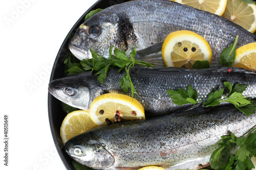 Fresh fishes with lemon, parsley and pepper