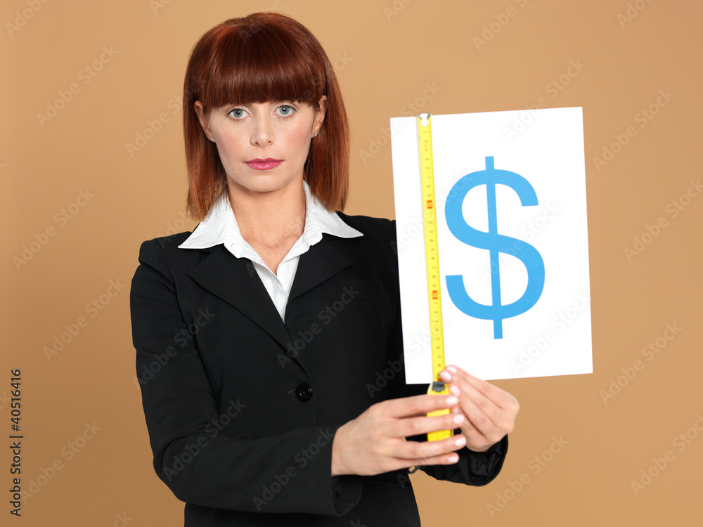 attractive, young businesswoman measuring dollar sign attractive, young businesswoman measuring dollar sign