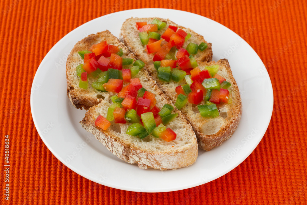 toasts with cut pepper on the plate