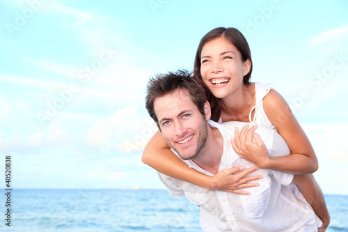 Happy beach couple piggyback © Maridav
