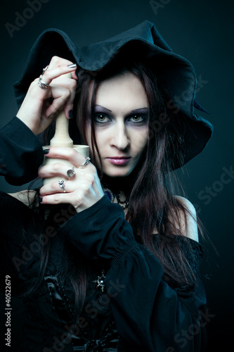 Witch with mortare and pestle photo