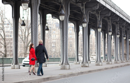 Romantic couple walking on the Bir-Hakeim bridge in Paris