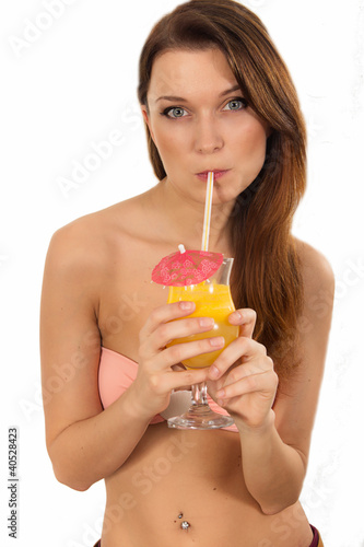 Beautiful woman in bikini drink juice through a straw