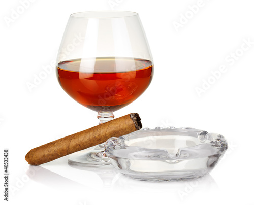 Obraz na płótnie Cognac in glass with cigar and ashtray isolated w salonie