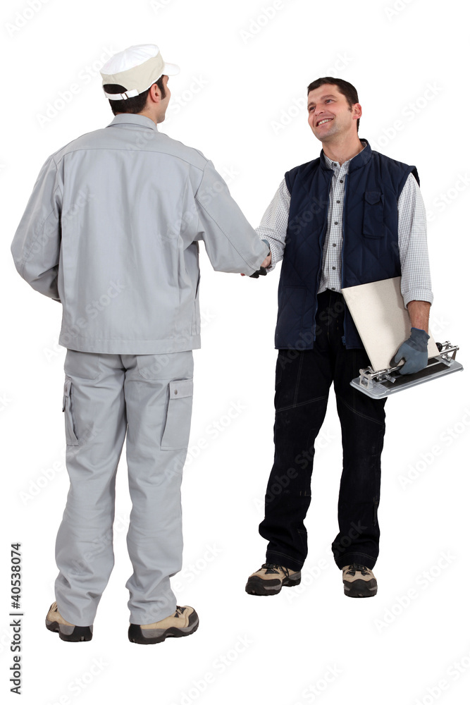tile cutter shaking hands with other worker tile cutter shaking hands with other worker