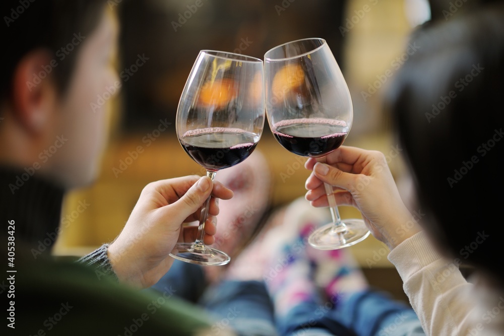 © .shock - Young romantic couple sitting on sofa in front of fireplace at h © .shock - Young romantic couple sitting on sofa in front of fireplace at h