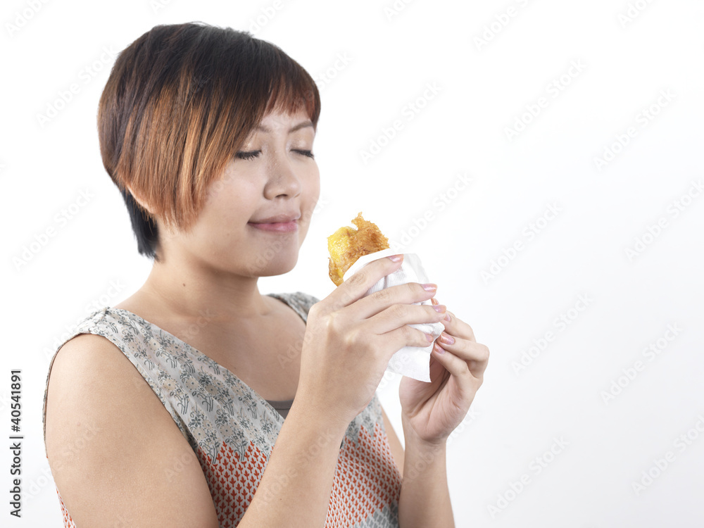 Chinese Asian Lady enjoying her snack Chinese Asian Lady enjoying her snack