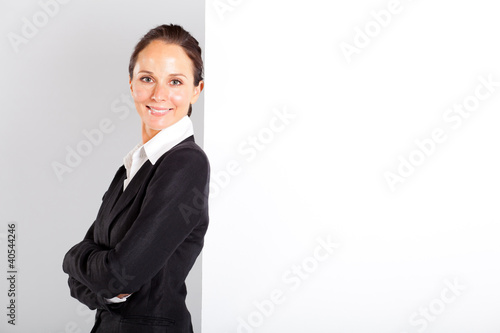 businesswoman standing next to white board