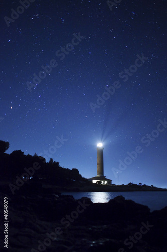 Lighthouse and stars at night