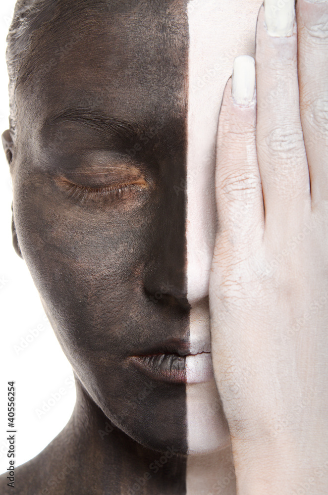 woman in two-color makeup covers eye with hand woman in two-color makeup covers eye with hand