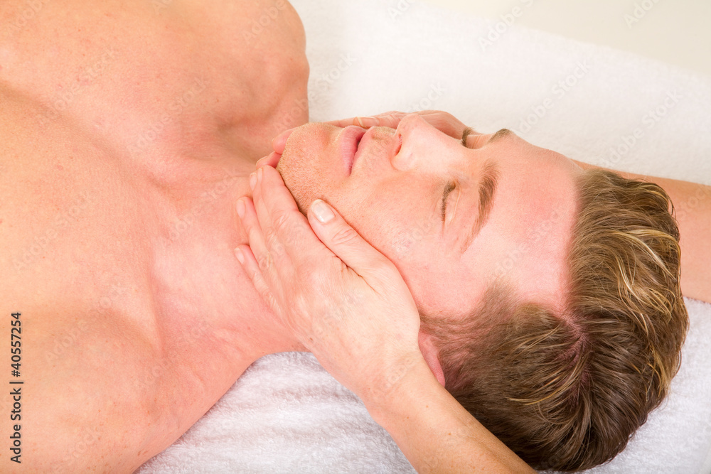 young man receives a face massage young man receives a face massage