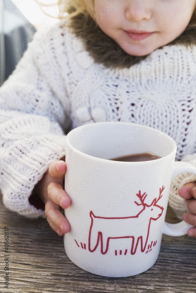 Small girl drinking large mug of cocoa Small girl drinking large mug of cocoa