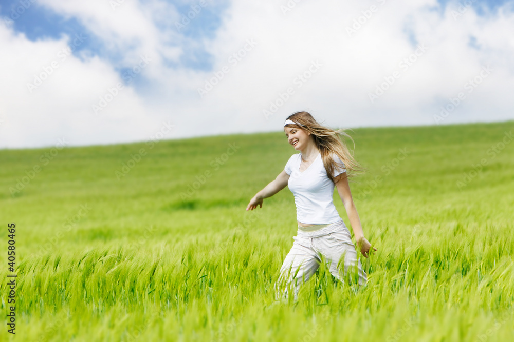 young beautiful woman running by green meadow young beautiful woman running by green meadow