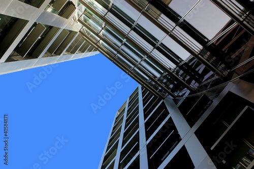 Blue sky peeking from in between architecture buildings