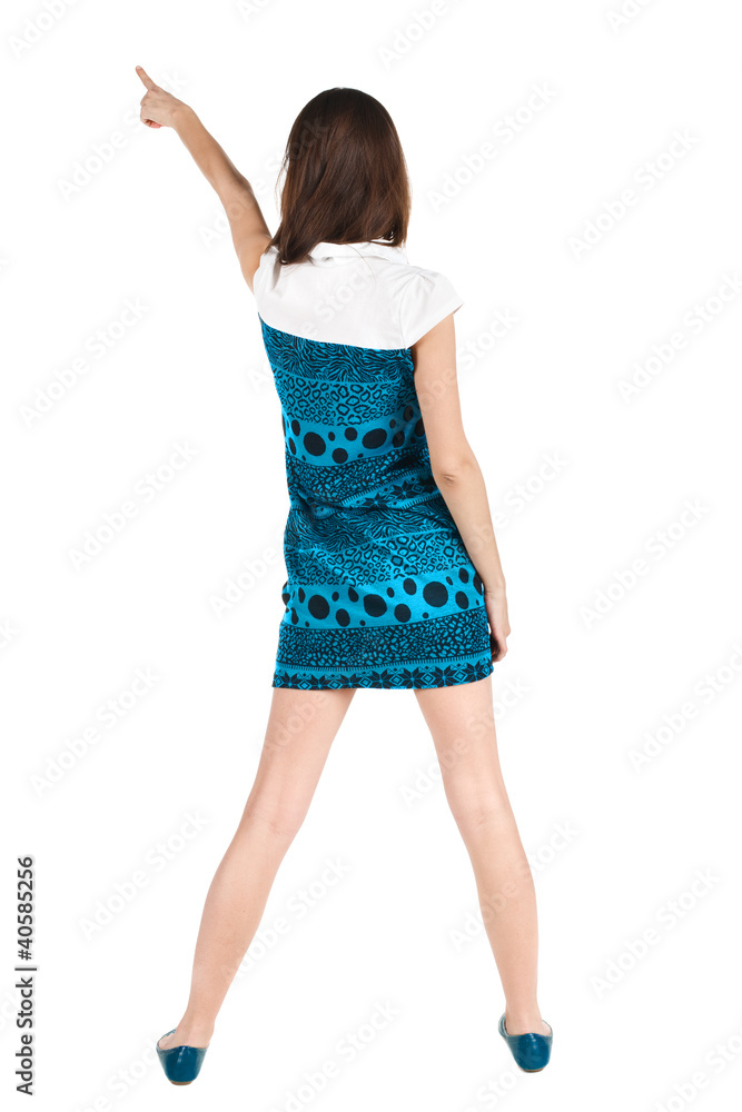 Back view of young brunette woman pointing at wall . Back view of young brunette woman pointing at wall .